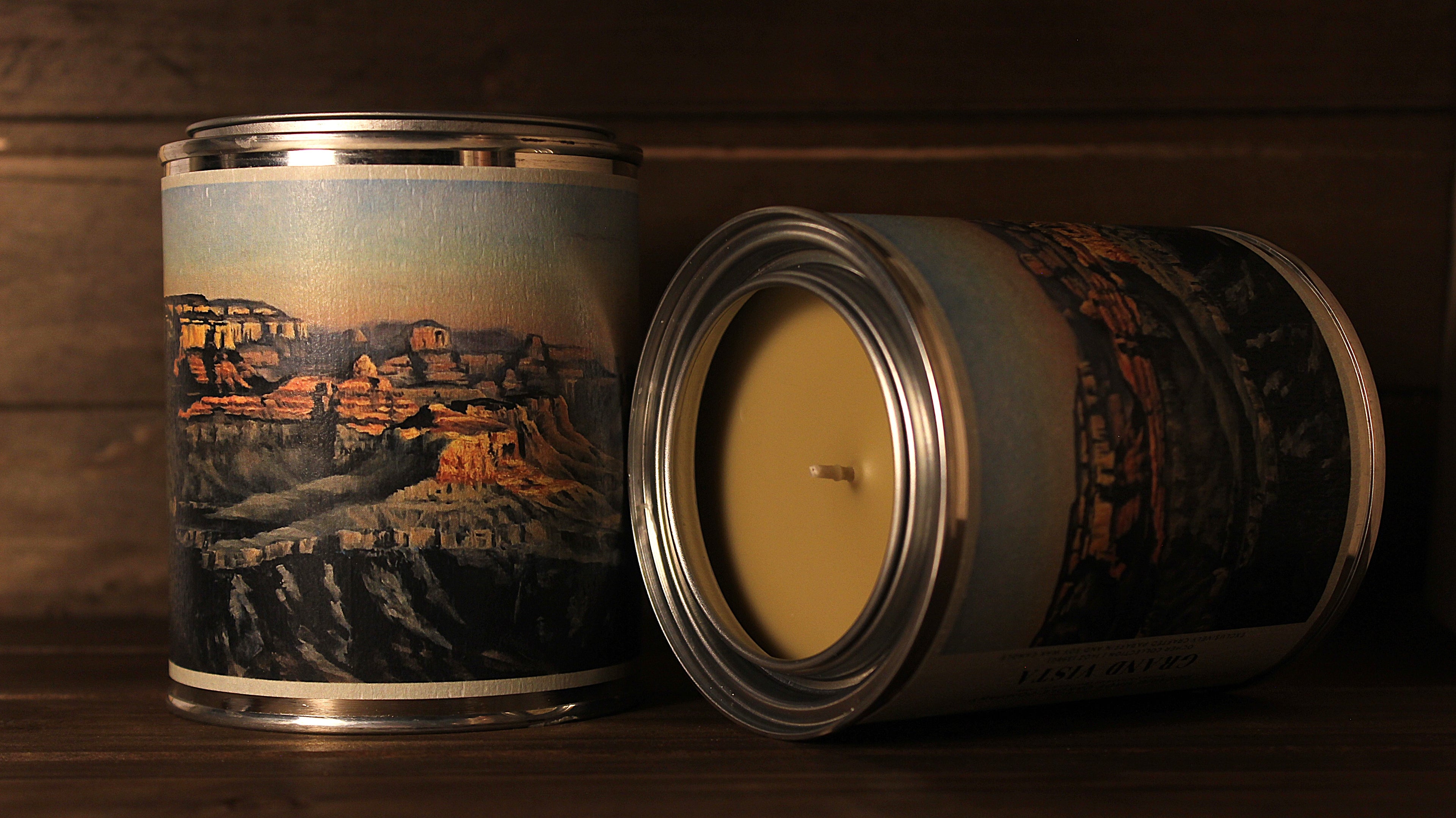 tin soy wax Candle with a scenic grand canyon design on a wooden surface