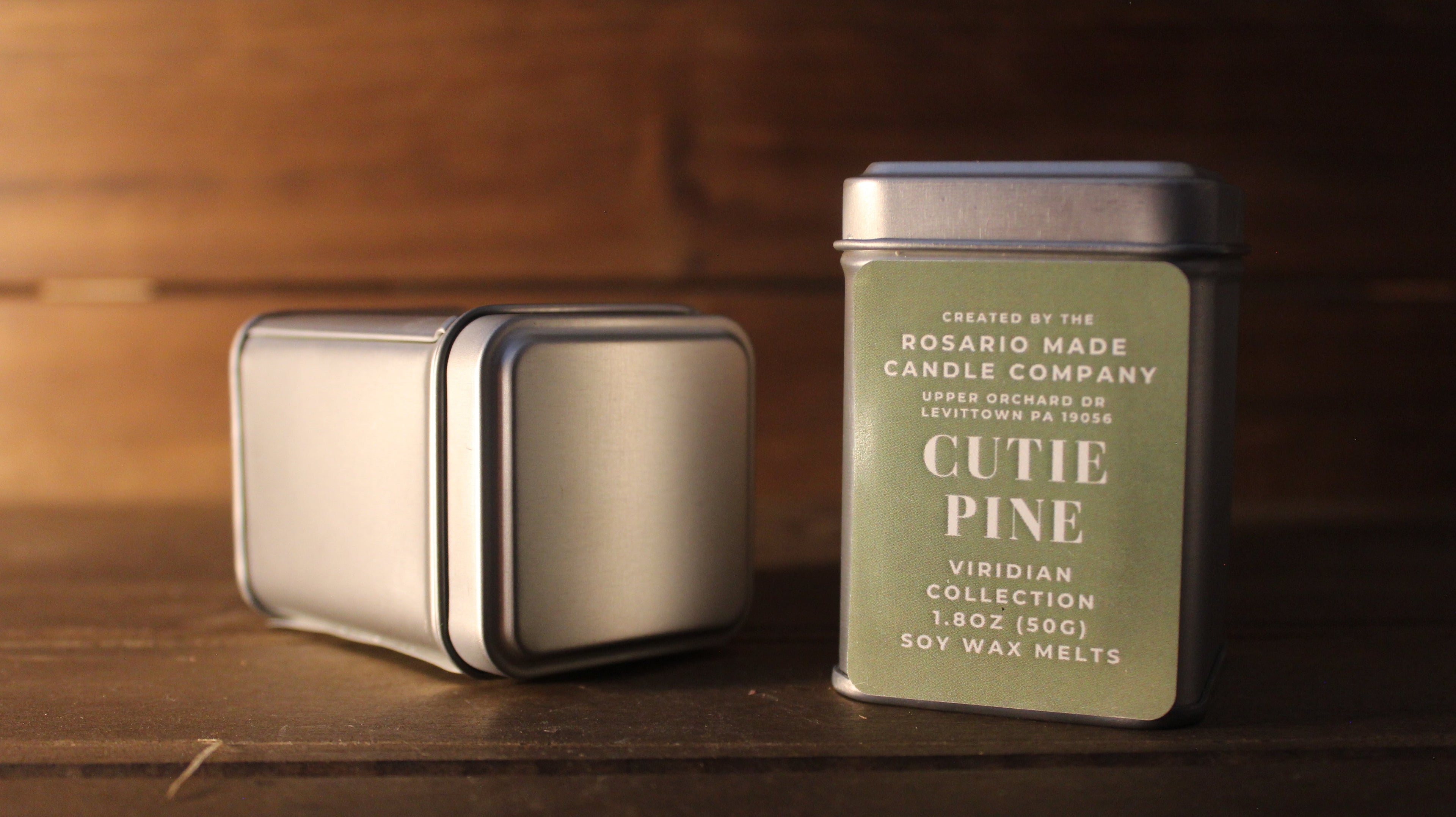 Fraser fir and Pine scented wax melts in a rustic metal tin on a wooden surface