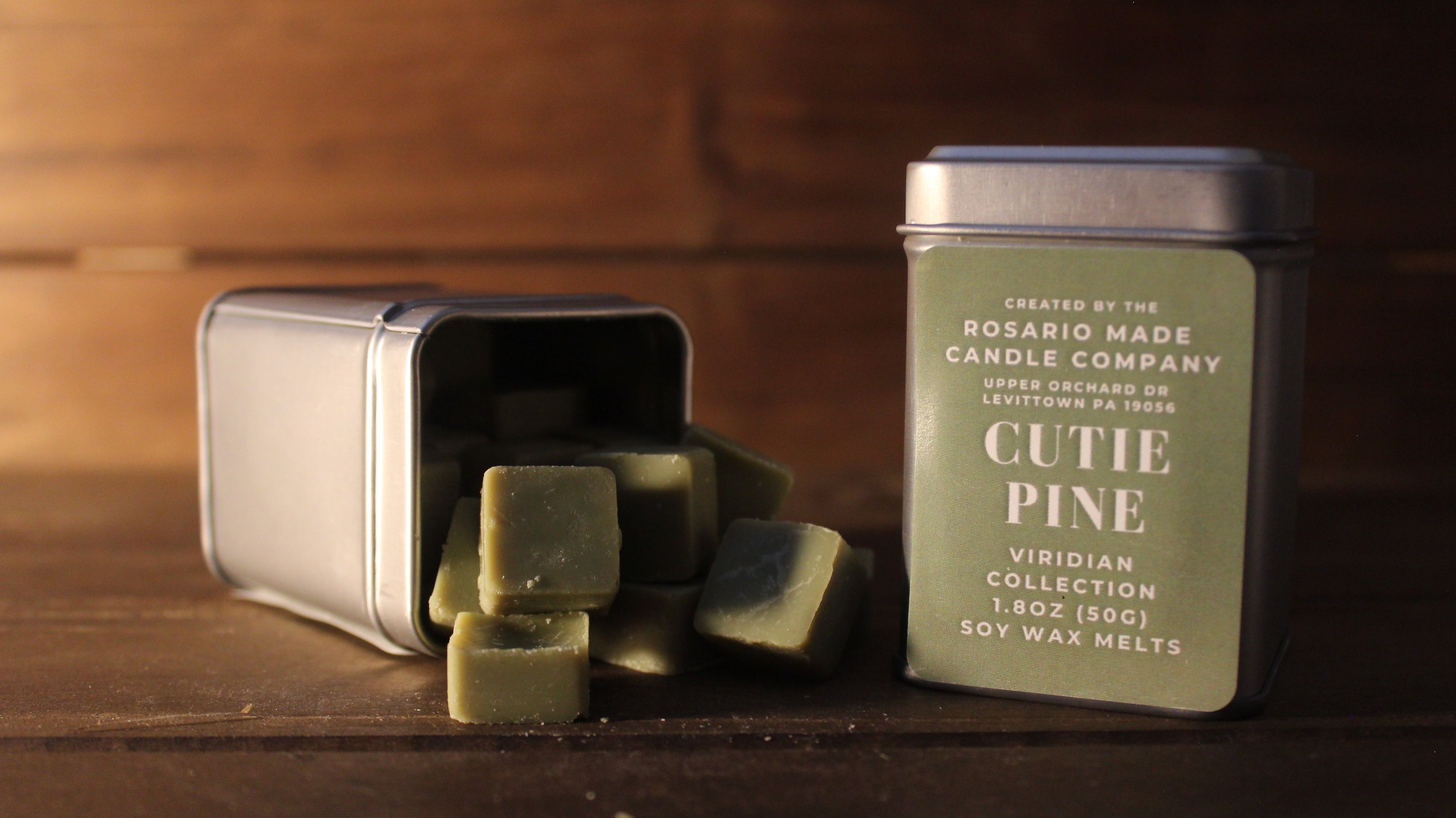 Fraser fir and Pine scented wax melts in a rustic metal tin on a wooden surface