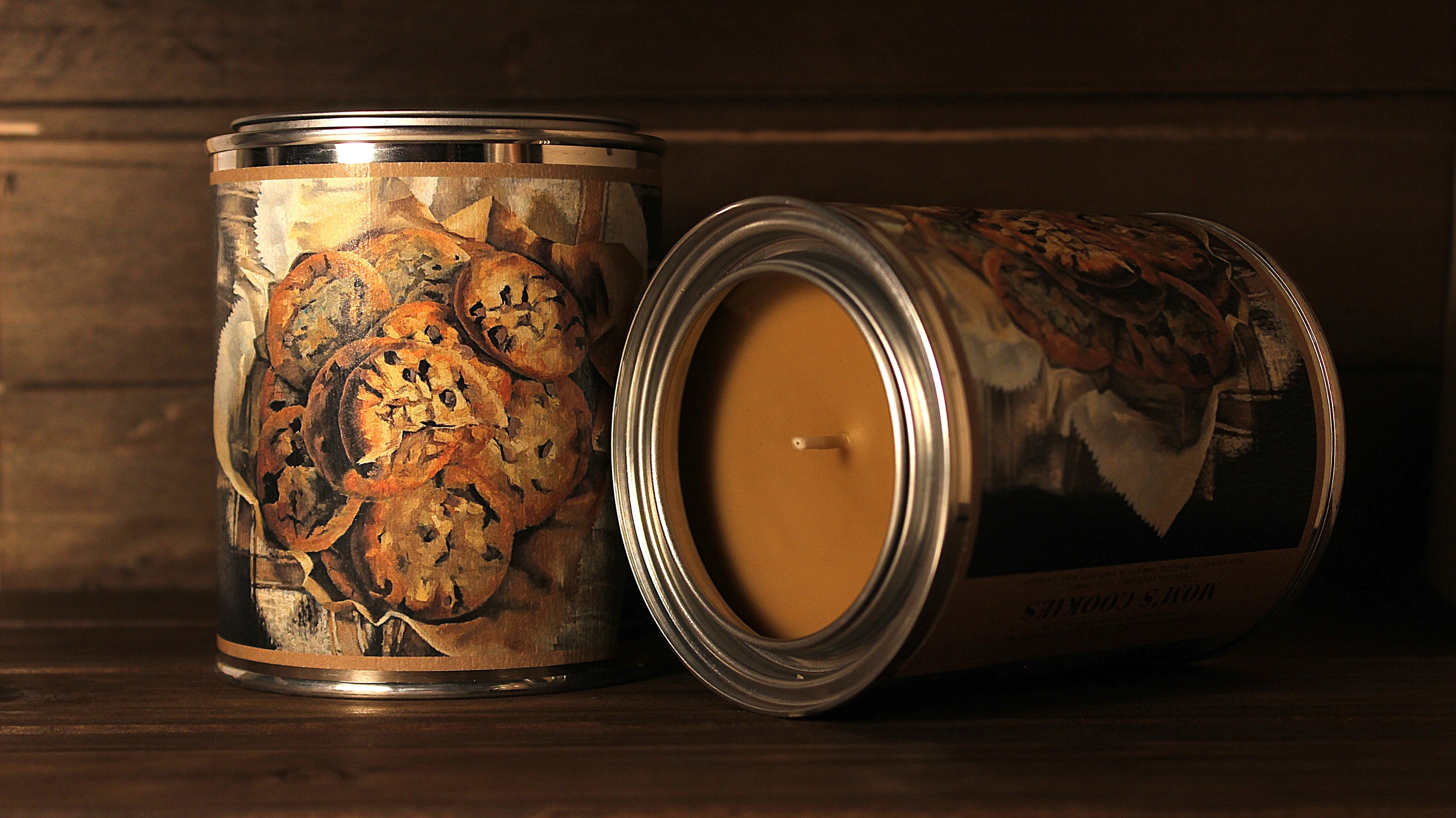 soy wax vanilla Candle in a decorative tin can with cookie design on a wooden surface